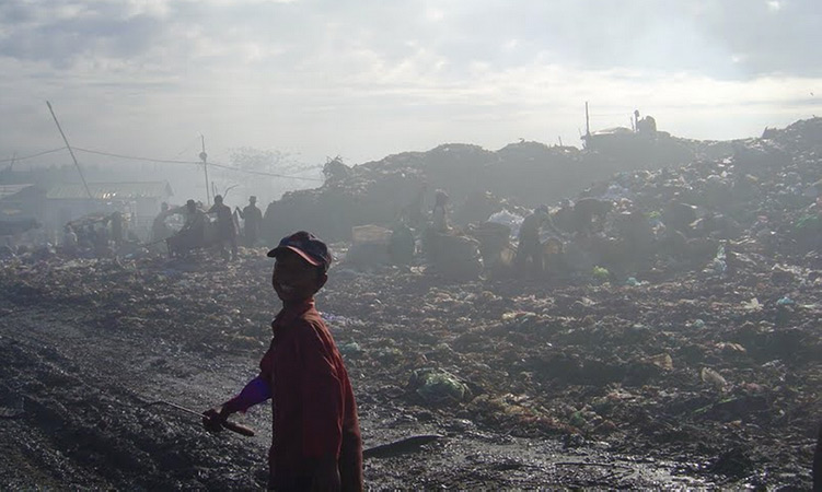 Child working as a 'waste picker' in Stung Meanchey, the largest garbage dump in Phnom Penh, Cambodia.